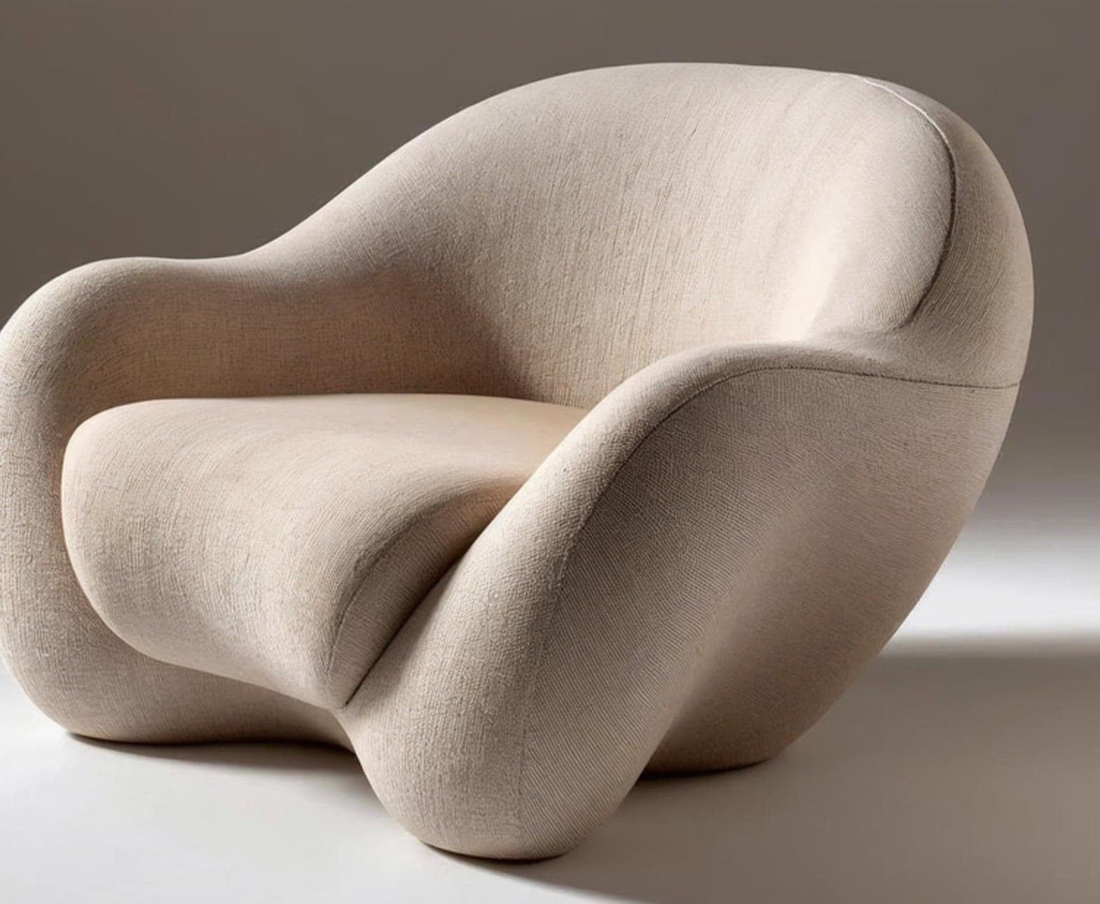 Sculptural upholstered armchair in cream bouclé, made to a bespoke commission