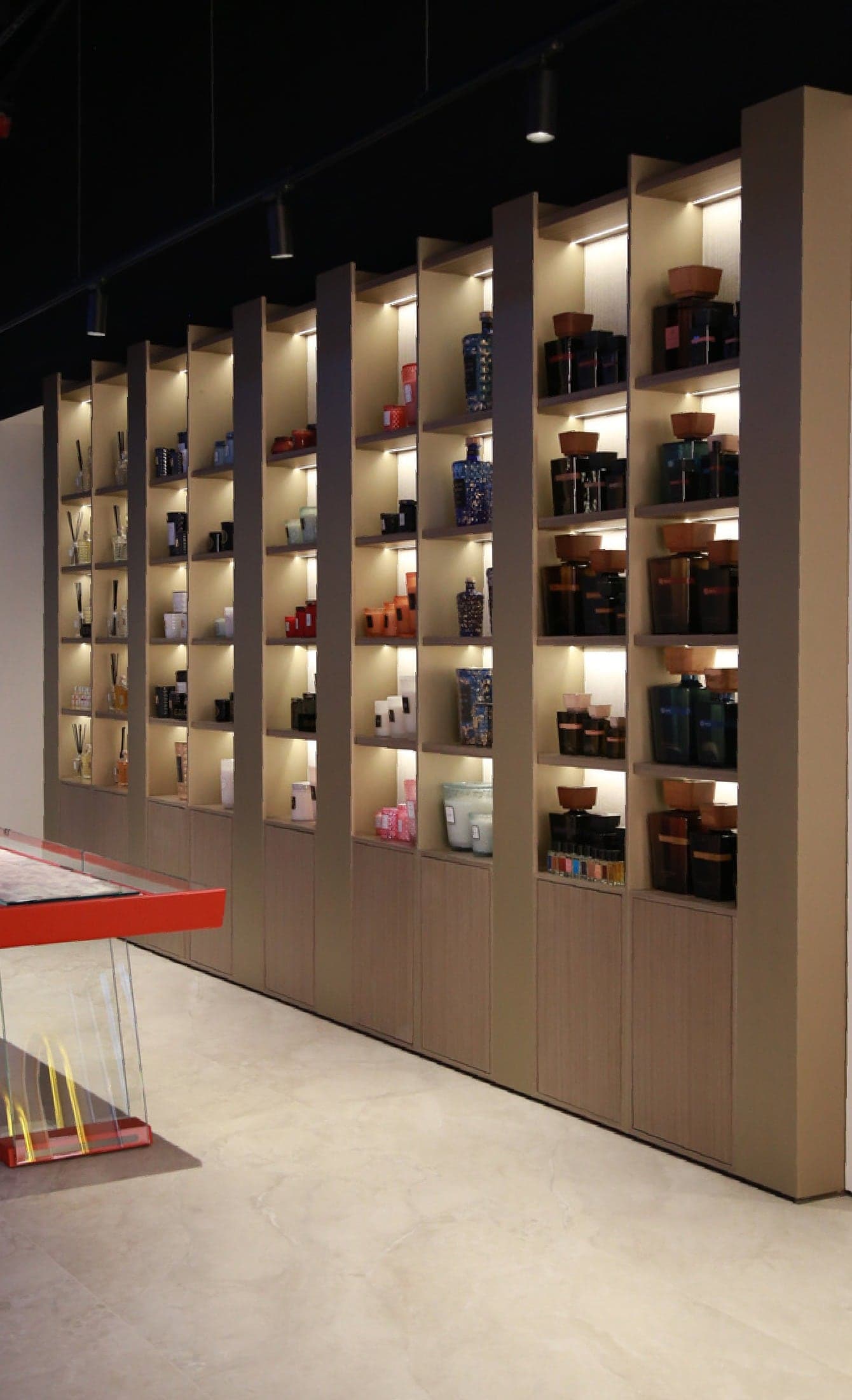 Full-height lit display shelving stocked with product